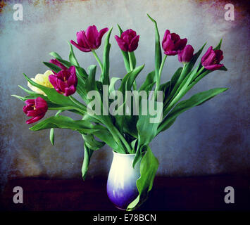 Vintage still life, vase with bouquet of puple tulips, Instagram-like retro filter and grunge texture added. Stock Photo