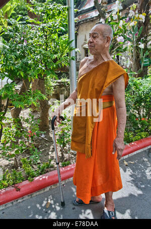 Monk walking with cane at Wat Kampaeng Khlong Bang Luang, Bangkok, Thailand Stock Photo