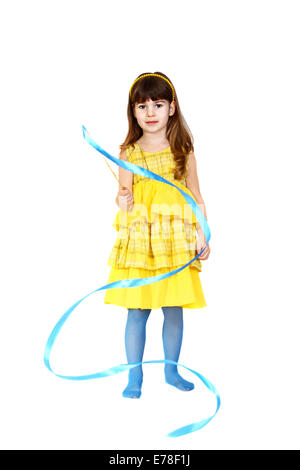 Cute little girl in yellow dress plays with blue ribbon. Portrait isolated on white background Stock Photo