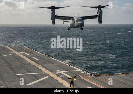 A U.S. Marine Corps MV-22 Osprey tiltrotor aircraft assigned to Marine Operational Test and Evaluation Squadron (VMX) 22 transports distinguished visitors and guests from Uruguay and prepares to land aboard the newly commissioned amphibious assault ship U