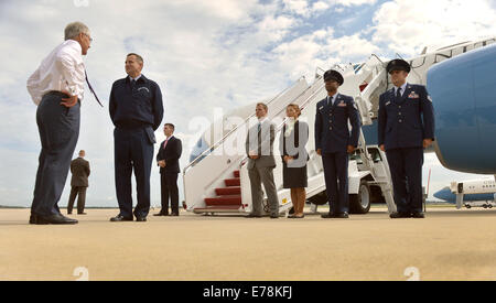 U.S. Air Force Col. John Millard, the commander of the 89th Air Wing, greets Secretary of Defense Chuck Hagel as Hagel arrives at an aircraft at Joint Base Andrews, Md., Sept. 3, 2014, as he prepares to go to Newport, R.I., for the Southeastern New Englan Stock Photo