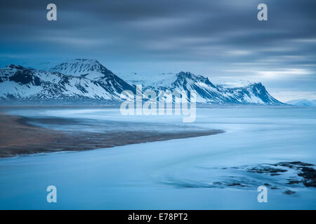 the coast at Budir with the mountains of Holsfjall and the Snaefellsnes Peninsula , western Iceland Stock Photo