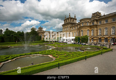 Formal gardens with water features and fountains, with Blenheim Palace, heritage listed English stately home, in background Stock Photo