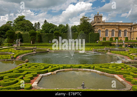 Formal gardens with water features and fountains, with Blenheim Palace, heritage listed English stately home, in background Stock Photo