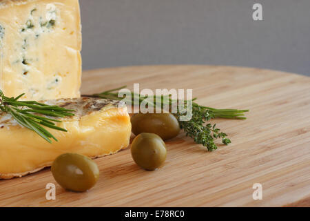 Cheese and Olives composition on wooden table Stock Photo