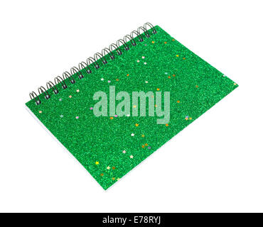 A green small notebook with a glitter cover on a white background. Stock Photo