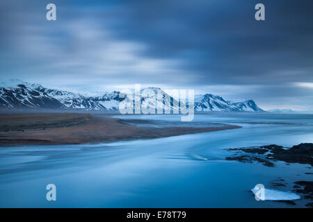 the coast at Budir with the mountains of Holsfjall and the Snaefellsnes Peninsula , western Iceland Stock Photo