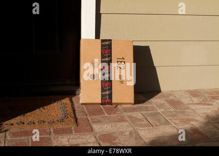 Amazon delivery left outside a house in Southern California wrapped with tape advertising the Fire phone Stock Photo