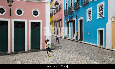 two girls running through the Pelourinho in the old town of Salvador, Bahia. Brazil Stock Photo