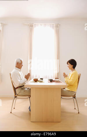 Senior adult Japanese couple in the kitchen Stock Photo