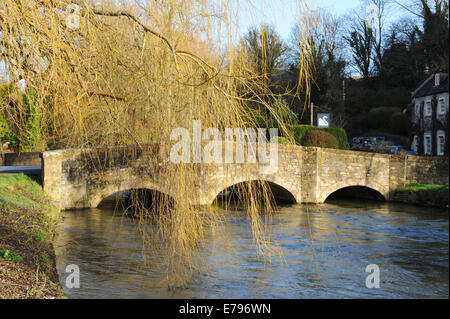 The old stone bridge in the very popular tourist village in the Cotswolds of Bibury, Gloucestershire, England, UK Stock Photo