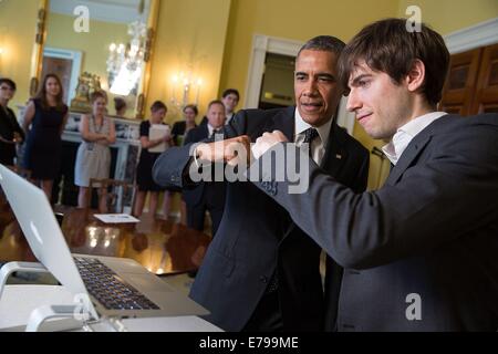 US President Barack Obama and Tumblr founder and CEO David Karp share a fist bump as they record a GIF in the Old Family Dining Room of the White House June 10, 2014 in Washington, DC. Stock Photo