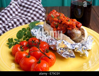 hotdog with bacon and tomato sauce and baked tomatoes Stock Photo