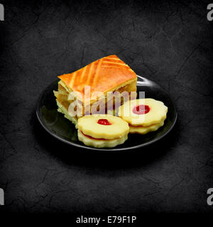 Apple pie and cookies with jam on a grunge background. Stock Photo