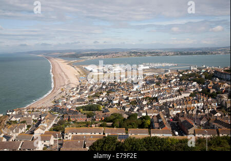 Chesil beach tombolo with housing in Chiswell in the foreground, Isle of Portland, Dorset, England Stock Photo