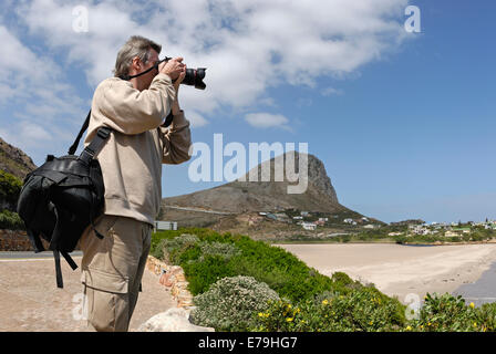 Man photographer taking photos of coastal landscape between Gordon's Bay and Betty's Bay, Western Cape Province, South Africa Stock Photo