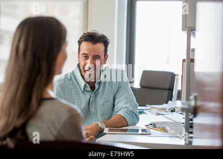 A woman and a man talking to each other. Stock Photo