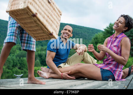 A family having a summer picnic at a lake. Stock Photo