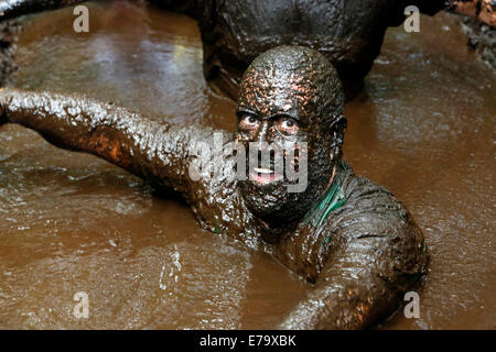 Man covered in mud and who has been taking part in a Mud Runner competition, Kilmarnock, Ayrshire, Scotland, UK Stock Photo