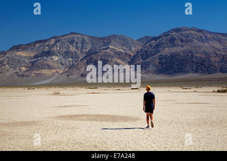 Boy on Salt Pan, Panamint Valley, and Panamint Range, Death Valley National Park, Mojave Desert, California, USA Stock Photo