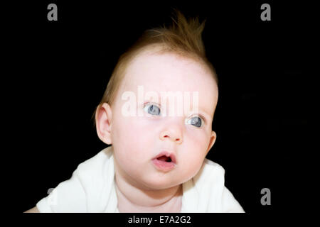 Portrait shot of an almost four month old baby girl on black background Stock Photo