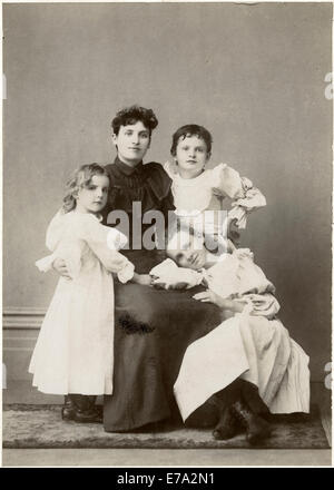 Woman in Dark Dress with Three Young Children in White Dresses, Portrait, circa 1910 Stock Photo