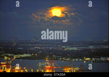 Full moon over Mactan Island and Cebu City Port Philippines Stock Photo
