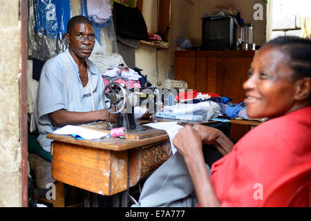 Two african dressmaker woman sews clothes on sewing machine and work with  scissors at tailor office. Black seamstress girls. 10417448 Stock Photo at  Vecteezy