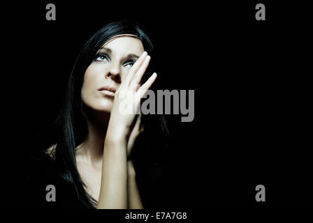 A beautiful woman staring up forlornly Stock Photo