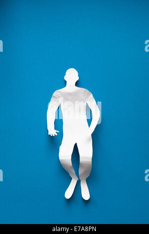 Directly above shot of tired paper man lying on blue background Stock Photo