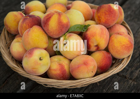 Close-up of peaches in basket Stock Photo