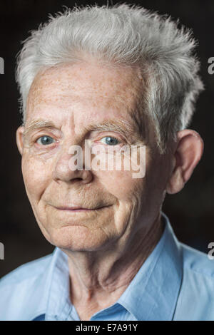 Close-up portrait of happy senior man over black background Stock Photo