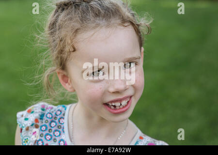 Portrait of cute girl smiling outdoors Stock Photo