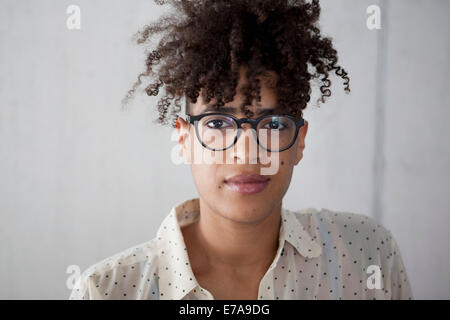 Portrait of young woman with curly hair at home Stock Photo