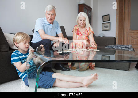 Grandparents and grandson spending leisure time in living room Stock Photo