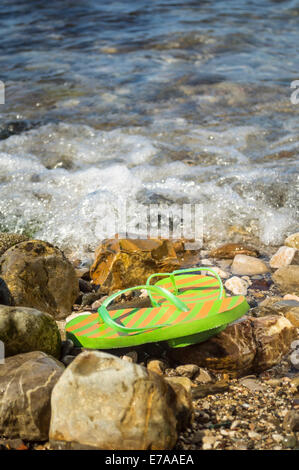 Flip flop on the beach. Shallow depth of field. Stock Photo