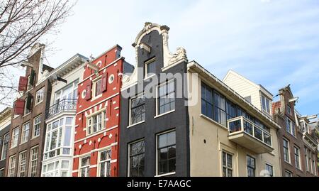 Colourful Amsterdam canal Houses on the corner of Leliegracht &  Herengracht, looking at gables and pulley systems Stock Photo