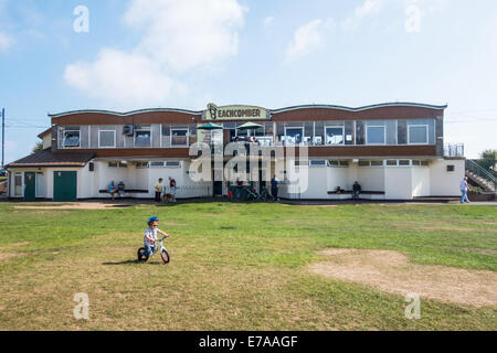 Teignmouth, Devon, England. The Beachcomber Café on Teignmouth sea front with a very small child on a bicycle in the foreground. Stock Photo