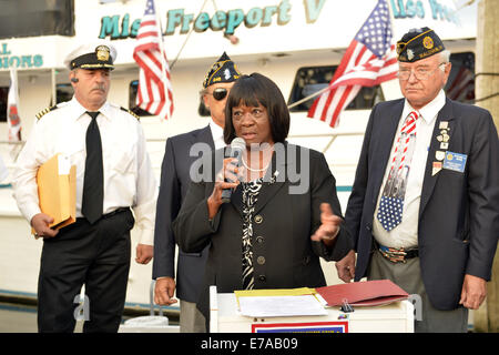 Freeport, New York, USA. 10th Sep, 2014. Town of Hempstead Councilwoman DOROTHY GOOSBY speaks at a dockside remembrance ceremony in honor of victims of the terrorist attacks of September 11 2001, at the boat Miss Freeport V, on Freeport's Nautical Mile. Further ceremonies were held on board the vessel, which sailed from the Woodcleft Canal on the South Shore of Long Island, on the eve of the 13th Anniversary of the 9/11 attacks. © Ann Parry/ZUMA Wire/Alamy Live News Stock Photo