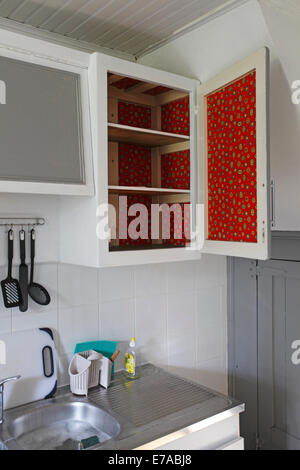 vintage kitchen cupboard with red fablon inside. Stock Photo