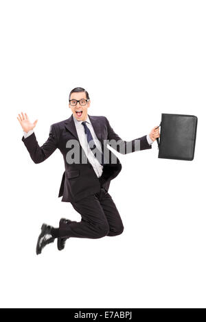 Businessman holding a case and jumping in the air isolated on white background Stock Photo