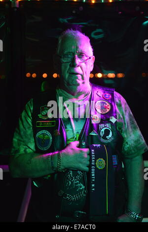 Freeport, New York, USA. 10th Sept. 2014. FRANK NEAL, of Hempstead, an American Legion Riders Post #1488 member, holds his hand over his heart while 'Gold Bless America' is sung, at night on board the boat Miss Freeport V, which sailed from the Woodcleft Canal of the Freeport Nautical Mile after a dockside remembrance ceremony in honor of victims of the terrorist attacks of September 11 2001. American Legion, Patriot Guard Riders, and Captain Frank Rizzo hosted the ceremonies on the eve of the 13th anniversary of the 9/11 attacks. Credit:  Ann E Parry/Alamy Live News Stock Photo