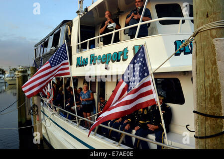 Freeport, New York, USA. 10th Sept. 2014. After a dockside remembrance ceremony in honor of victims of the terrorist attacks of September 11 2001, on Freeport's Nautical Mile, further ceremonies were held on board the boat Miss Freeport V, which sailed from the Woodcleft Canal on the South Shore of Long Island, on the eve of the 13th Anniversary of the 9/11 attacks. Credit:  Ann E Parry/Alamy Live News Stock Photo