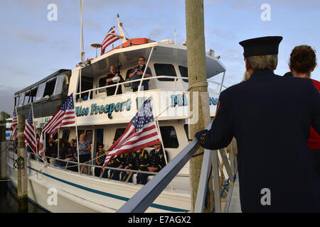 Freeport, New York, USA. 10th Sep, 2014. After a dockside remembrance ceremony in honor of victims of the terrorist attacks of September 11 2001, passengers walk up the gangplank to board the boat Miss Freeport V, which sailed from the Woodcleft Canal on Freeport's Nautical Mile on Long Island, on the eve of the 13th Anniversary of the 9/11 attacks. Further ceremonies were held on the boat. Credit:  Ann Parry/ZUMA Wire/Alamy Live News Stock Photo