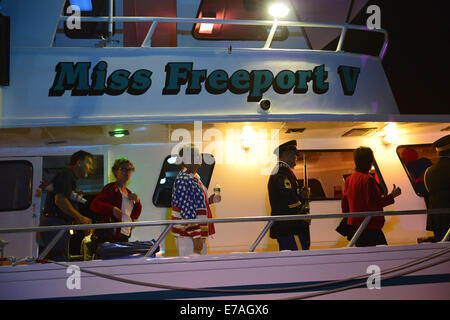 Freeport, New York, USA. 10th Sep, 2014. After a remembrance ceremony dockside and on board Miss Freeport V in honor of victims of the terrorist attacks of September 11 2001, the boat returns to Woodcleft Canal on Freeport's Nautical Mile, where passengers lined up to disembark, on the eve of the 13th Anniversary of the 9/11 attacks. Credit:  Ann Parry/ZUMA Wire/Alamy Live News Stock Photo