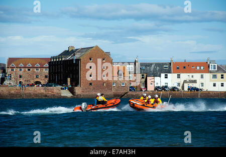 RNLI volunteers in inflatable boats outside North berwick harbour, Scotland. Stock Photo