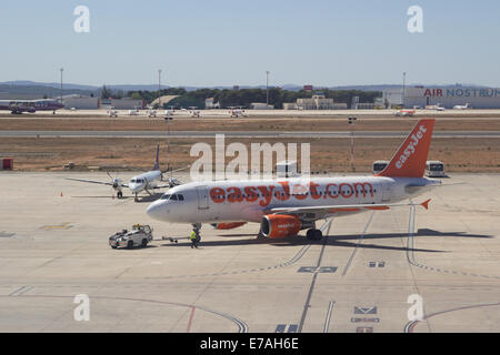Valencia, Spain. 11th September, 2014. An EasyJet airliner at the Valencia Airport. EasyJet is a British airline carrier based at London Luton Airport.  It is the largest airline of the United Kingdom, by number of passengers carried, operating domestic and international scheduled services on over 600 routes in 32 countries. Stock Photo