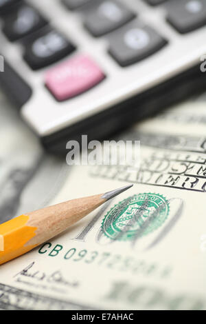 Calculator, pencil and dollars. Shallow depth of field. Close-up. Stock Photo