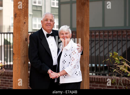 A happy mature couple dressed for a black tie event Stock Photo