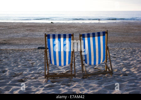 Two deck chairs on Porthmeor beach at sunset, St Ives, Cornwall, England, UK Stock Photo